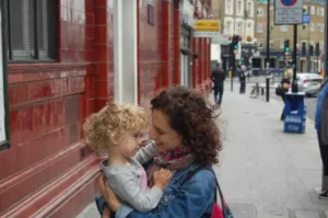 Andrea Ferretti holding daughter on the street