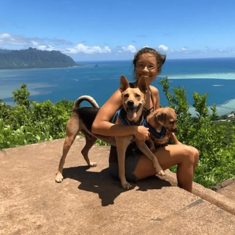 Nicole Bell with a dog at a beach