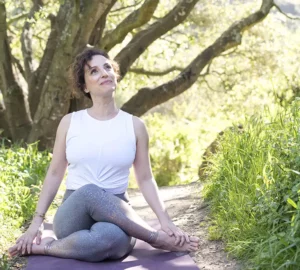 Andrea Ferretti in a yoga pose outdoors