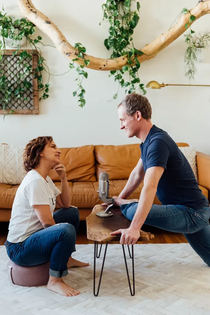 Jason Crandell in a creative Pigeon pose and Andrea Ferretti, recording a Yogaland podcast episode