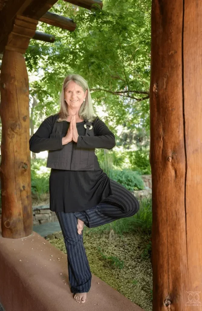 Cyndi Lee in a tree pose outside