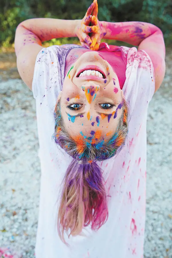 Kathryn Budig doing backbend covered in paint, photographed from above