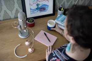 Andrea Ferretti sitting at a desk, working, drinking coffee