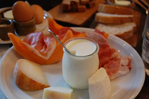 A plate of fruits and yogurt